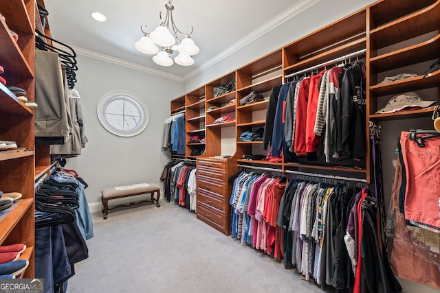 spacious closet with a notable chandelier and carpet floors