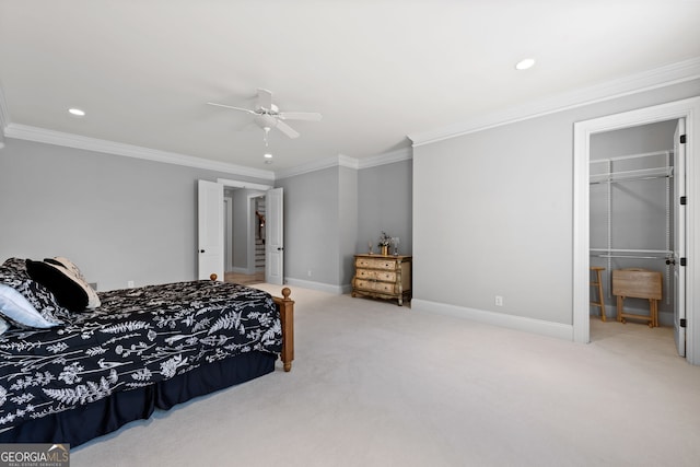 carpeted bedroom with ceiling fan, a closet, and crown molding