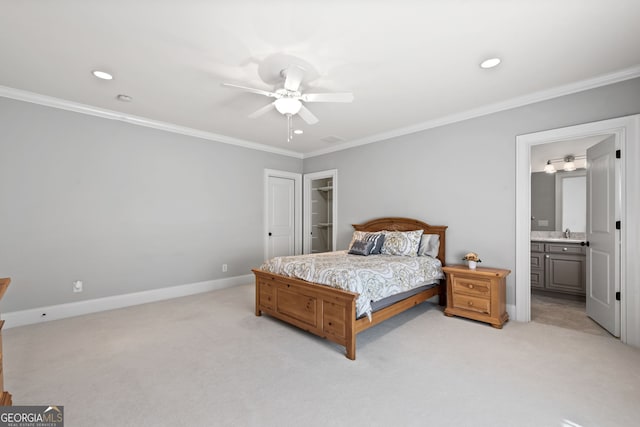 bedroom featuring ornamental molding, light carpet, ensuite bath, a closet, and ceiling fan