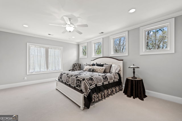 bedroom with multiple windows, ceiling fan, carpet floors, and crown molding