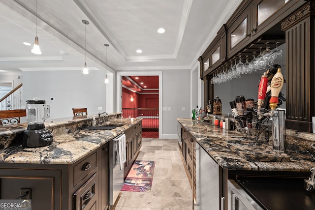 kitchen with crown molding, dark stone countertops, decorative light fixtures, dark brown cabinetry, and sink