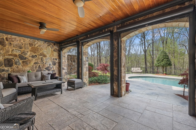 view of patio with an outdoor hangout area, ceiling fan, and a fenced in pool