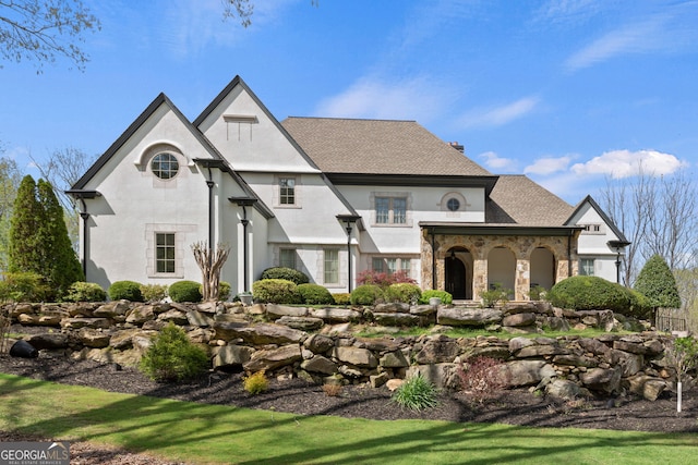 113 Hawks Ct, Ball Ground, GA 30107 - back of house featuring stone siding, stucco siding, a shingled roof, and a chimney