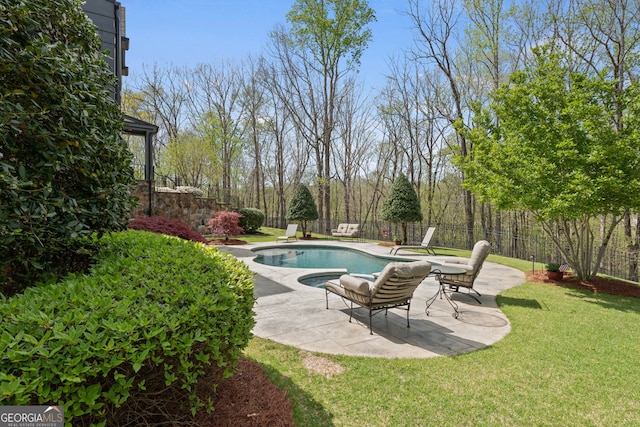 view of pool with a patio area and a lawn