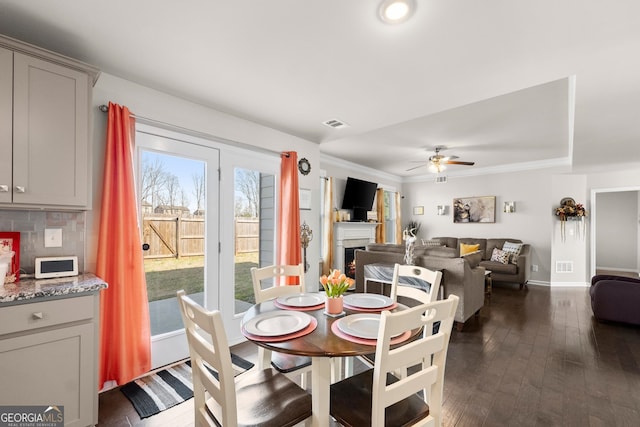 dining space featuring dark hardwood / wood-style flooring and ceiling fan