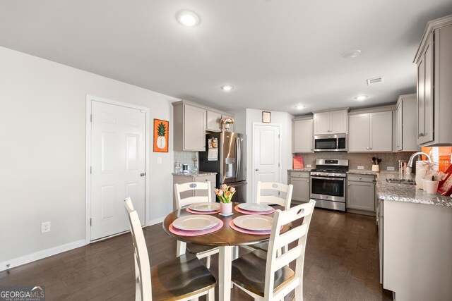 dining space with dark hardwood / wood-style floors and sink