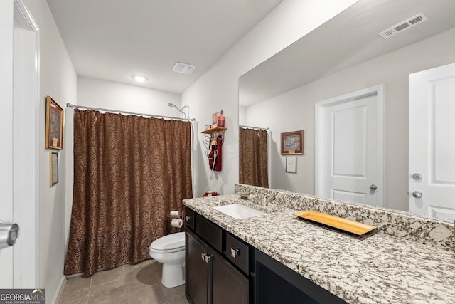 bathroom with toilet, tile flooring, and large vanity