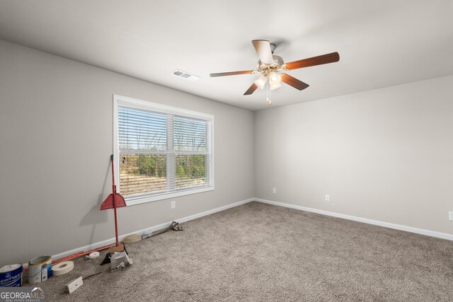 carpeted spare room featuring ceiling fan