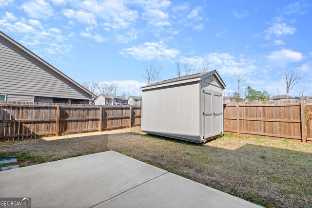 view of yard with a patio and a storage unit