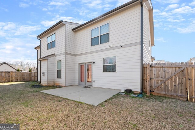 rear view of house featuring a patio and a yard