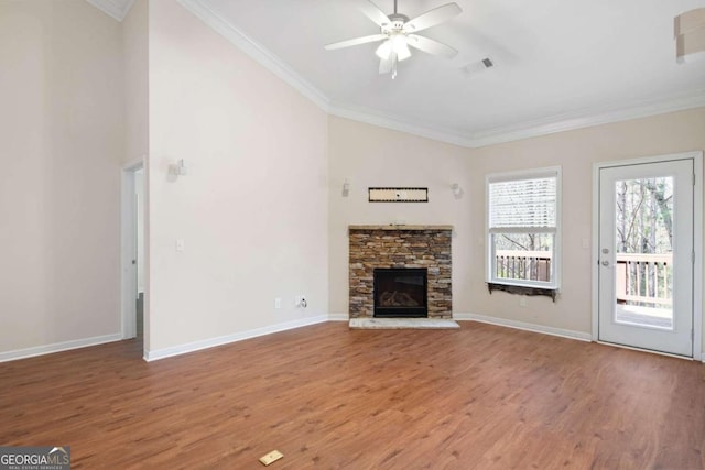 unfurnished living room featuring a fireplace, plenty of natural light, ceiling fan, and light wood-type flooring