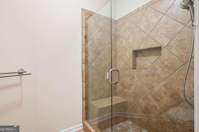 bathroom with a shower with shower door