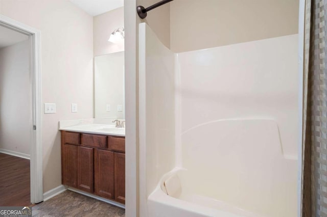 bathroom featuring shower / bathtub combination, vanity, and hardwood / wood-style flooring