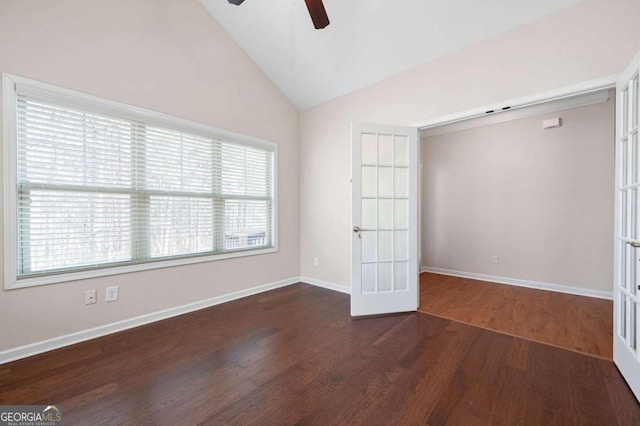 spare room with high vaulted ceiling, ceiling fan, french doors, and dark hardwood / wood-style flooring