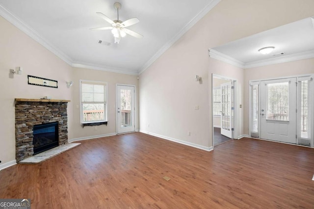 unfurnished living room with ceiling fan, crown molding, dark wood-type flooring, and a fireplace