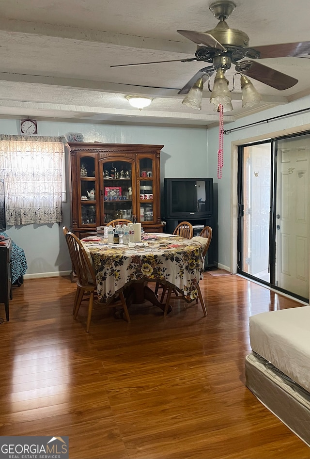 dining area featuring ceiling fan, a textured ceiling, and hardwood / wood-style floors