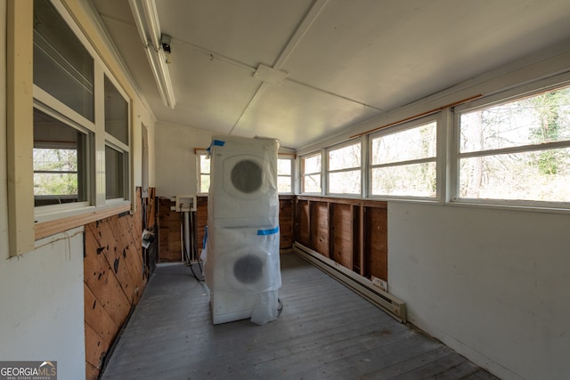 sunroom with plenty of natural light and a baseboard heating unit