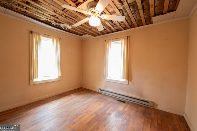 unfurnished room featuring hardwood / wood-style flooring, ceiling fan, and a baseboard heating unit