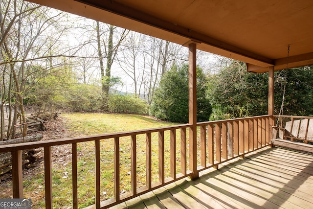 wooden deck with a yard