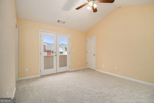 spare room with french doors, ceiling fan, vaulted ceiling, and light colored carpet