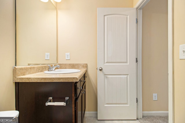 bathroom featuring vanity, tile floors, and toilet