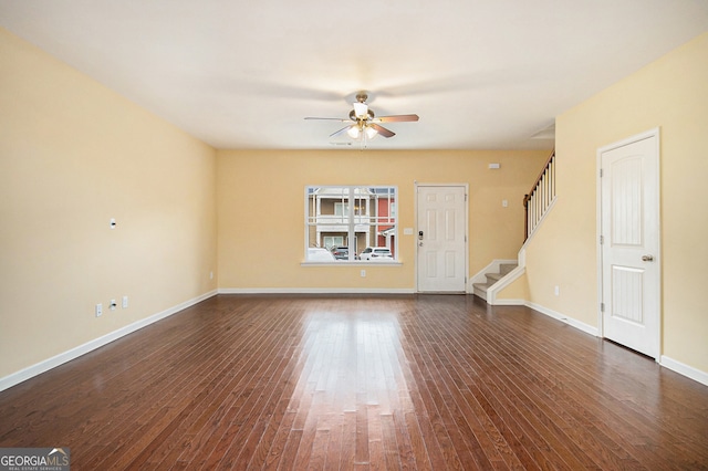 empty room with dark hardwood / wood-style floors and ceiling fan