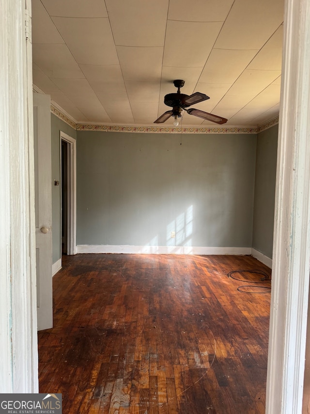 unfurnished room with dark hardwood / wood-style flooring and ceiling fan