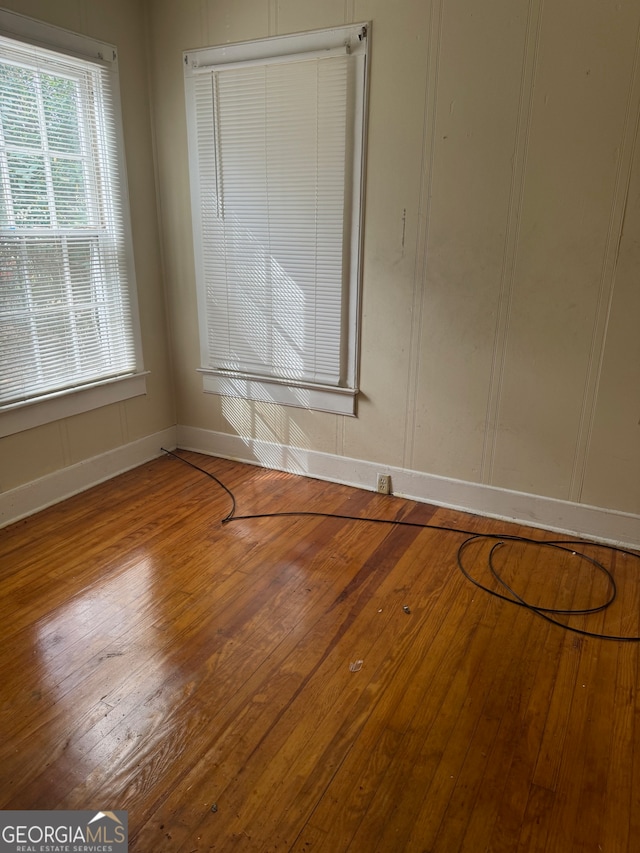 unfurnished room featuring hardwood / wood-style flooring