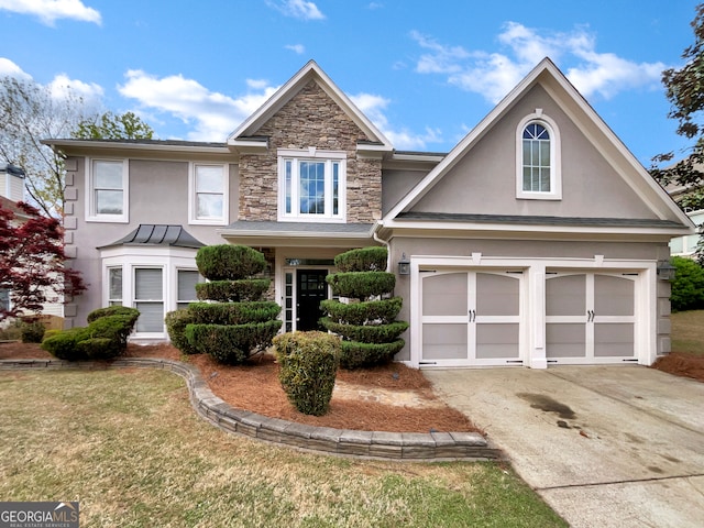 view of front of house featuring a front lawn and a garage