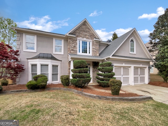 view of front of house with a front lawn and a garage