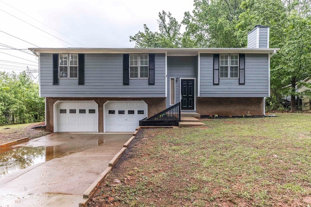 bi-level home with a garage and a front yard