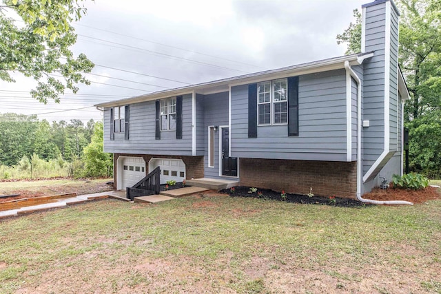 raised ranch with a garage and a front yard