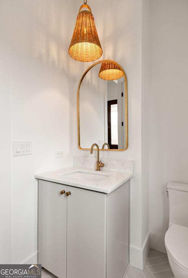 bathroom featuring vanity and toilet