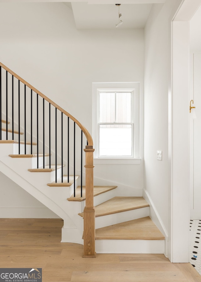 stairway with hardwood / wood-style floors