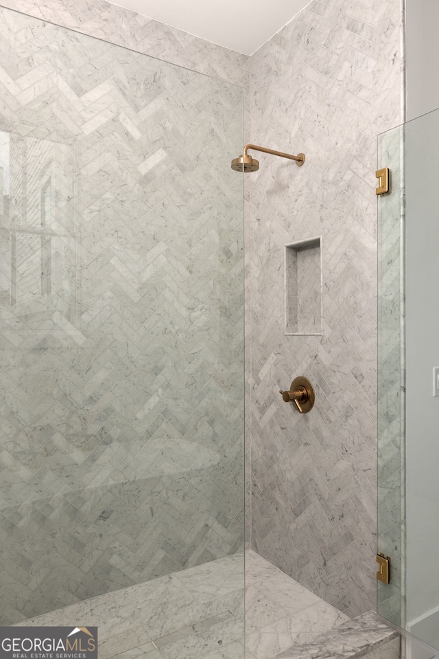 bathroom with tiled shower