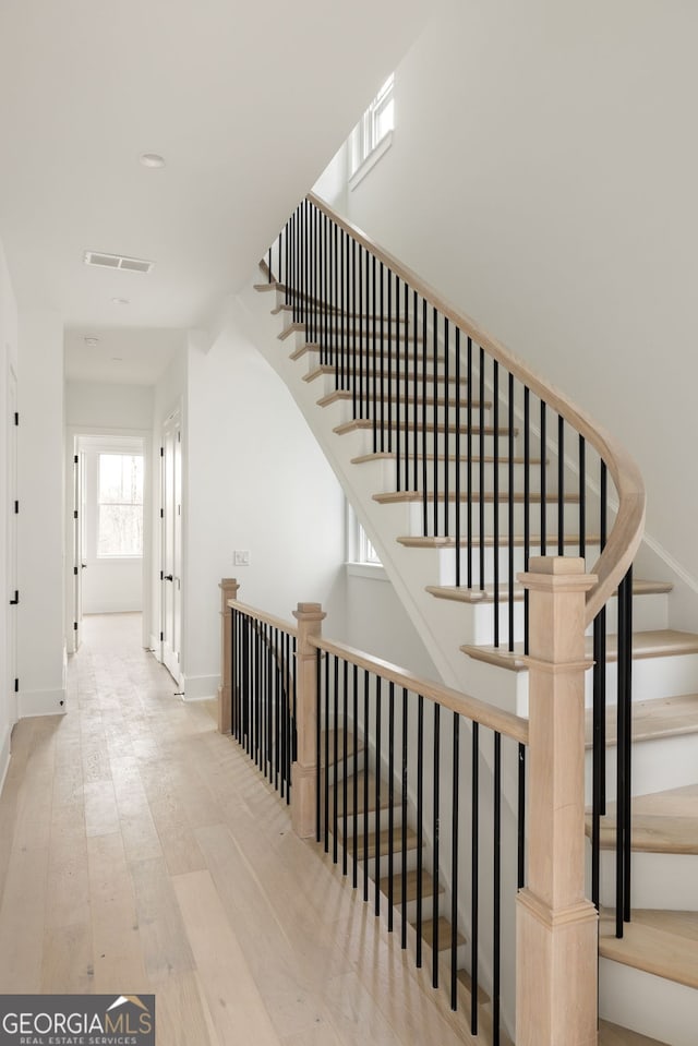 staircase featuring hardwood / wood-style floors