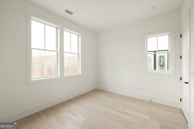 spare room with light hardwood / wood-style flooring