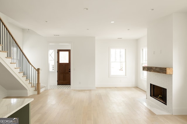 entryway with a wealth of natural light and light wood-type flooring