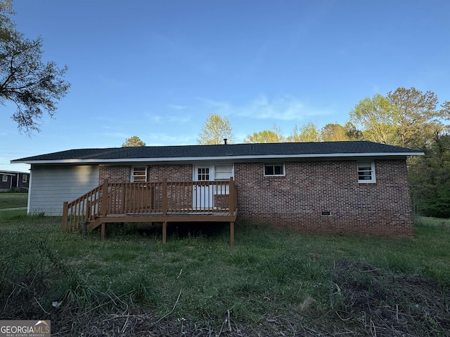 rear view of property with a wooden deck