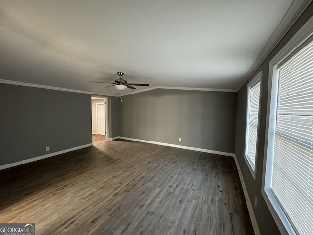 spare room featuring ceiling fan, dark hardwood / wood-style flooring, lofted ceiling, and ornamental molding