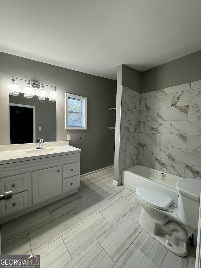 full bathroom with vanity, toilet, and tiled shower / bath