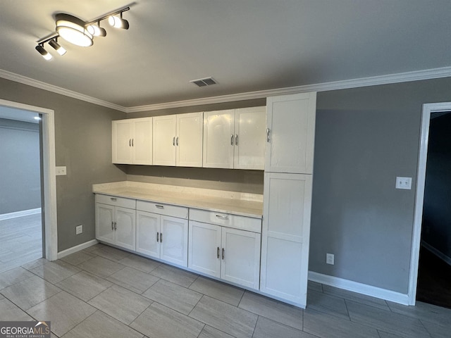 kitchen with white cabinetry and crown molding