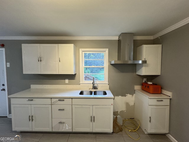 kitchen with white cabinets, sink, and wall chimney exhaust hood