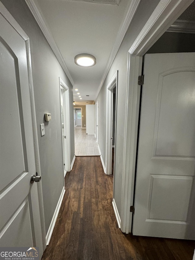 corridor featuring dark hardwood / wood-style flooring and crown molding