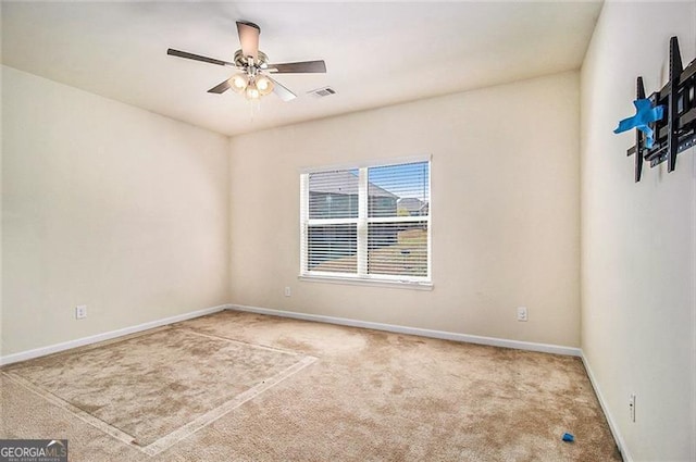 carpeted spare room featuring ceiling fan