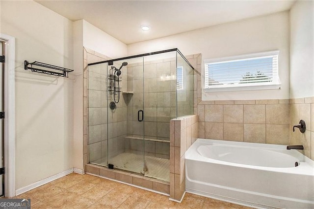 bathroom featuring shower with separate bathtub and tile flooring