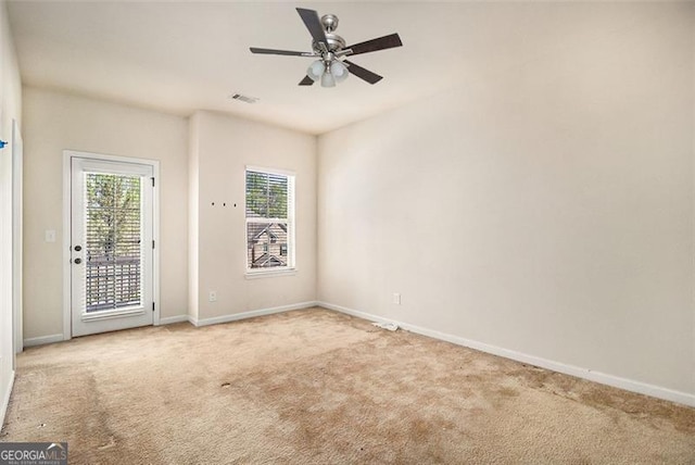 unfurnished room with light carpet and ceiling fan