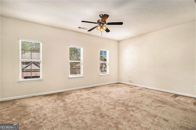 carpeted spare room with ceiling fan