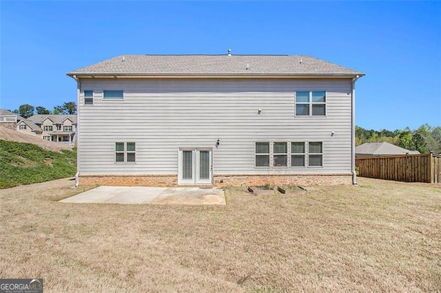 rear view of property with a yard and a patio