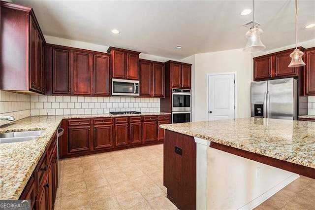 kitchen featuring backsplash, hanging light fixtures, and stainless steel appliances